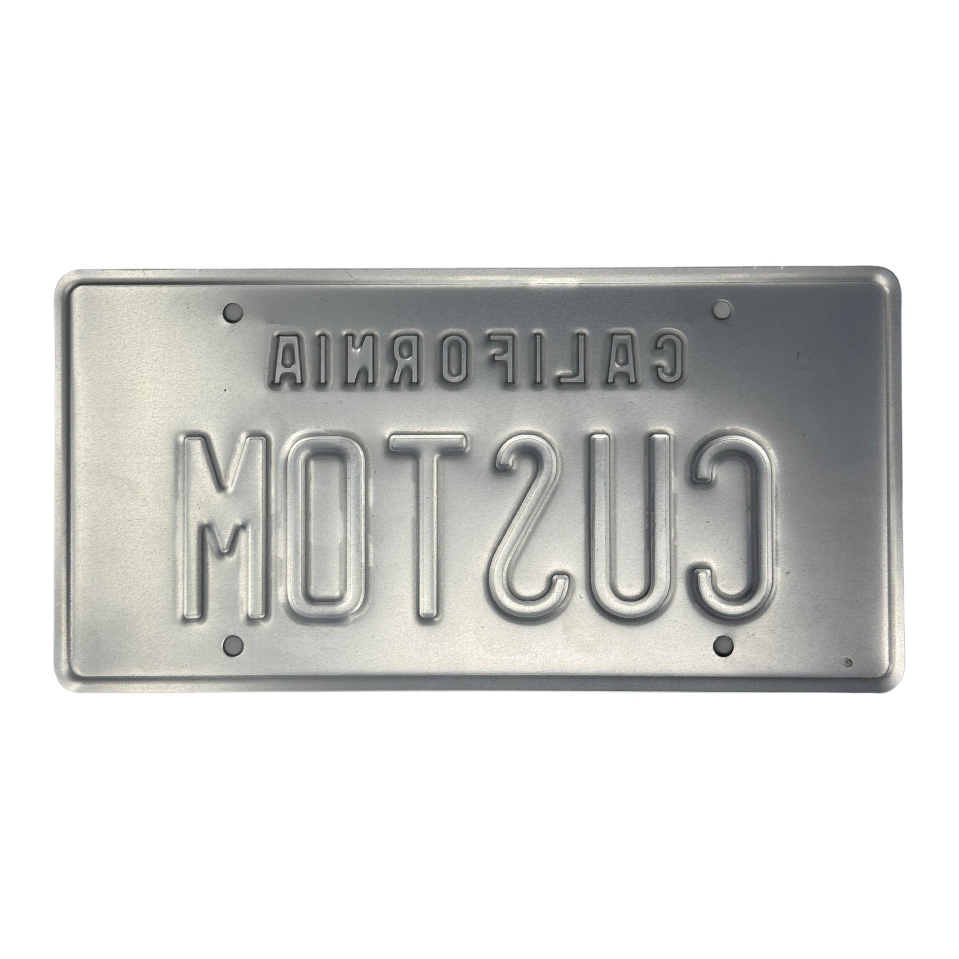 This is the backside of the embossed black and yellow California Legacy style license plate in which you can see both the California and the letters are stamped into the license plate. 