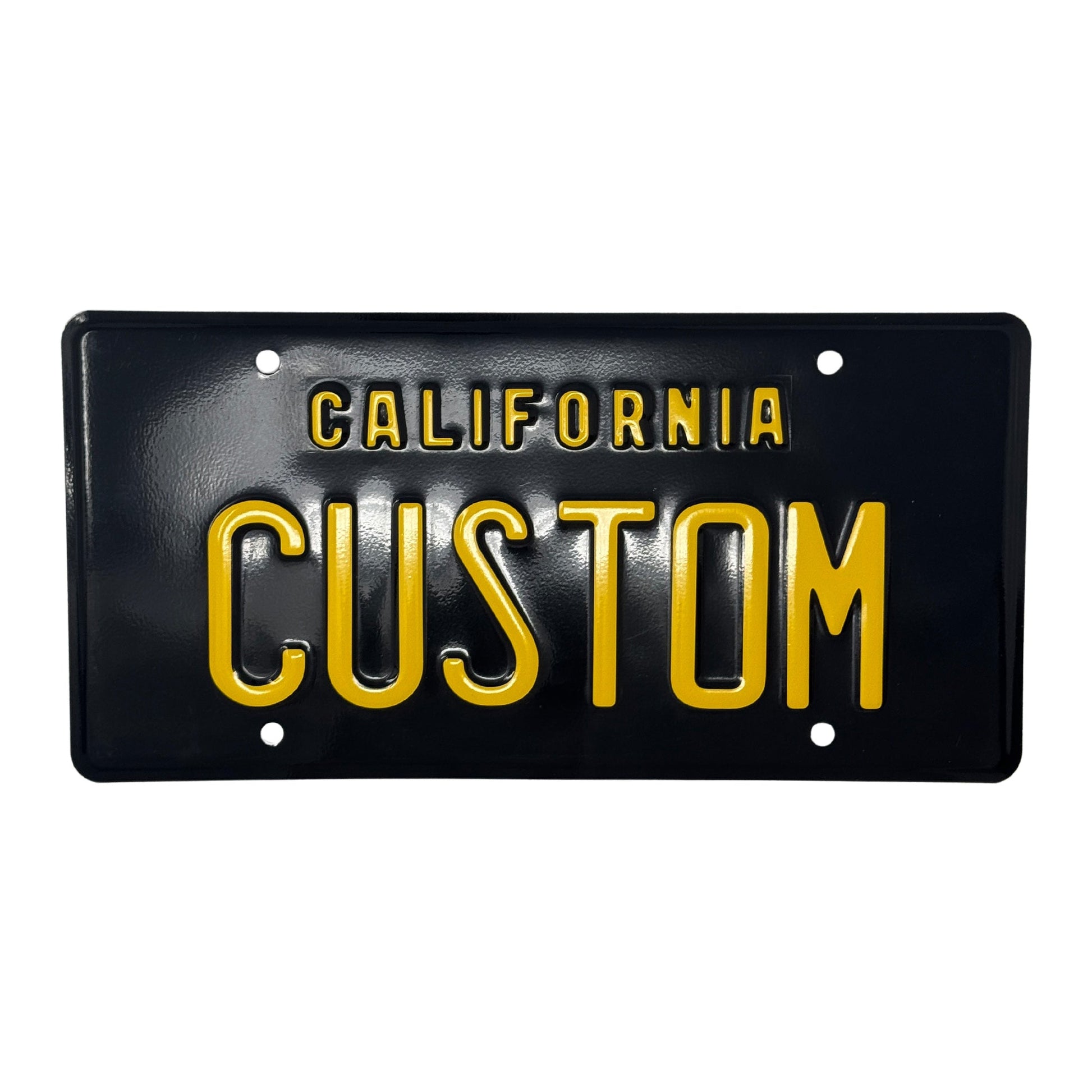  The license plate is a black and yellow license plate that has the legacy style embossed with raised lettering "California" with the license plate reading "CUSTOM."